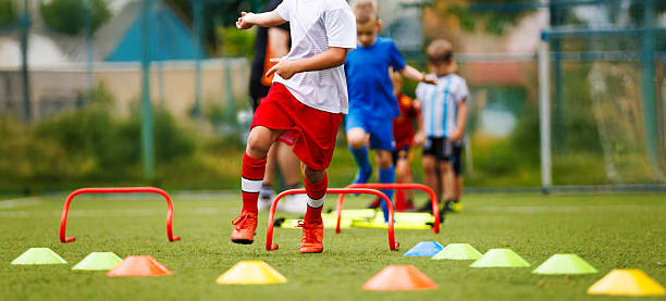 Player working through a cone and hurdle drill